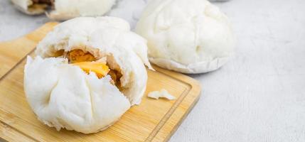 The Chinese  food menu of Steamed Buns split in the middle reveals Pork Belly on white table photo