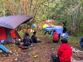 Blitar, Indonesia August 17th. A group of climbers who are chatting and enjoying the morning air with several tents in the background photo