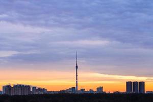 Early blue sunrise and skyline with TV tower photo