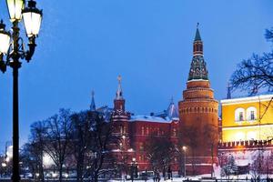 Kremlin tower and Alexander Garden in winter snowing evening, Moscow photo