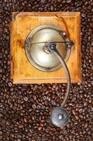 retro manual coffee mill on roasted beans photo