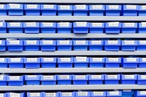 blue plastic boxes in storage stand photo