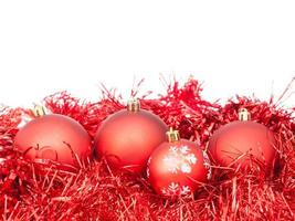 few red Xtmas baubles and tinsel isolated photo