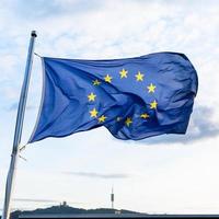 european union flag fluttering on wind photo