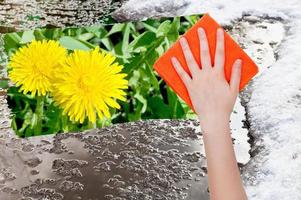 hand deletes melting snow by orange cloth photo
