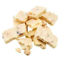 heap of broken white chocolate with hazelnuts photo