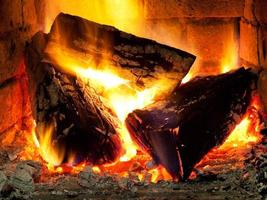 burning fuelwood in fireplace photo