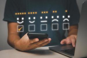 Customer review satisfaction feedback survey.Give very satisfied rating with smiley face icon service experience on online application concept. photo