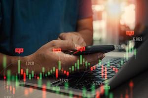 Stock market trading investments exchange graph on screen.man trader investor analyst using mobile phone data index chart on smartphone. photo