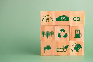 wood cube block icon co2 carbon credit and eco energy green technology on green background. photo