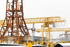 tower and gantry cranes in metal product warehouse photo