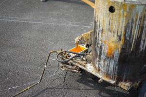 Workers are lining on the asphalt roat with paint the thermoplastic by machine photo