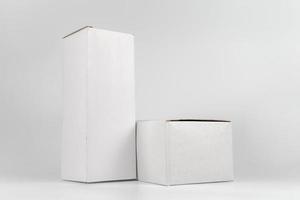 White two paper boxes - tall and fat lay on the white background in studio shot with clipping paht. photo