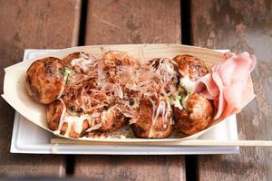 Takoyaki, Local Japanese octopus meat ball on the wood table, ready to eat. photo