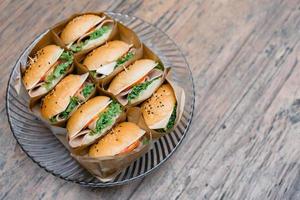 A group of homemade HAMBURGER is wrapped with paper craft and arranged on the dish, ready to serve and eat. photo