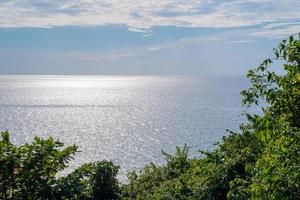 The tree is foreground in front of seascape and horizontal line with open clear sky and cloud. This place is Koh Kood Thailand. photo