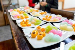 Traditional Golden and colorful Thai Dessert JaMongKut, SaNayChan, ThongAek, MedKaNoon and Woon are set in seperated square white dish for serve to meeting member. photo