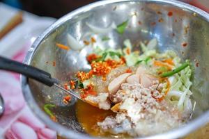 Cooking Thai traditional food called Yam Woon Sen  Glass Noodle,Pork,Nut Spicy Salad, Mung Bean Noodle Spicy Salad. photo