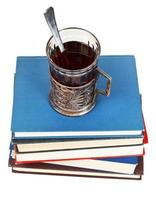 glass of tea on stack of books photo
