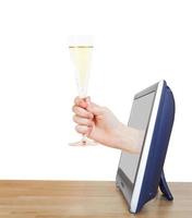 hand raising glass with champagne leans out TV photo