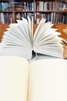 open books on wooden table photo