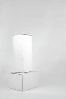 White two paper boxes - tall and fat lay on the white background in studio shot with clipping paht. photo