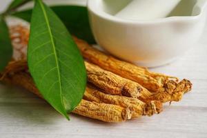 Ginseng roots and green leaf, healthy food. photo