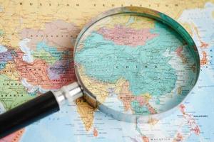 Bangkok, Thailand - May 15, 2022 Magnifying glass on world map. photo