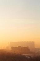 orange sunrise sky over urban houses in winter photo