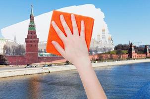 hand deletes summer view of Moscow by orange cloth photo