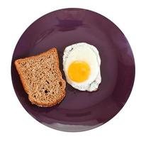 top view of fried egg and toasted rye bread photo