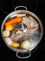 simmer of beef broth with seasoning vegetables photo