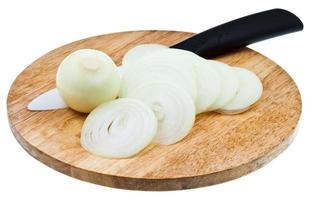 bulb and sliced onions with ceramic knife on board photo