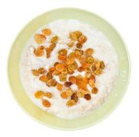 oat porridge with raisins in ceramic bowl photo