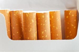 cigarette filters in box close up photo