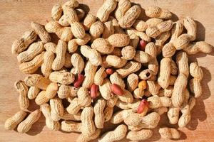 roast peanuts on wooden board photo