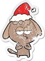 distressed sticker cartoon of a bored dog wearing santa hat vector