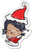 distressed sticker cartoon of a woman sitting wearing santa hat vector