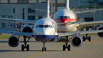 FRANKFURT AM MAIN, GERMANY JULY 21, 2017 - British Airways Airbus 320 G EUPO taxiing and China Eastern Airbus 330 B 5938 towing to service. Fraport, Frankfurt, Germany video