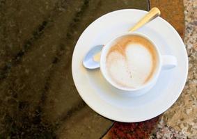 cup of cappuccino on stone table photo