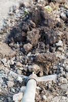 digging a hole by shovel close up photo