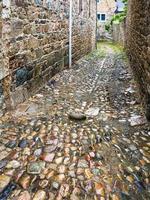 wet pavement of narrow street in Treguier photo