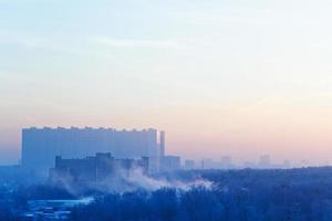 sunrise mist and blue and pink sky over city photo