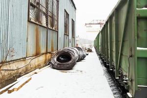 reinforcement rolls near warehouse on railroad photo