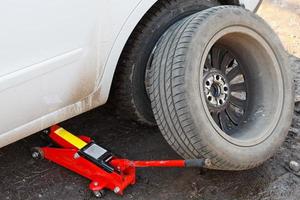 lifting car by hydraulic jack photo