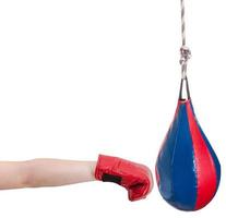 kid with boxing glove punches punching bag photo
