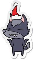 angry wolf sticker cartoon of a wearing santa hat vector