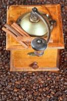 retro manual coffee mill on roasted beans photo