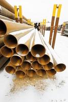 rusty steel pipes in stacks on outdoor warehouse photo