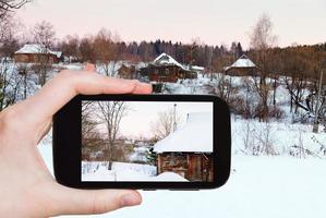 tourist photographs of snowy wooden houses photo